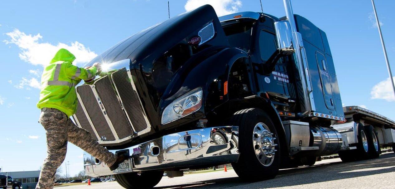 A commercial truck driving on a highway, showcasing the importance of comprehensive trucking insurance coverage available through Insurance Company Bexley Ohio.