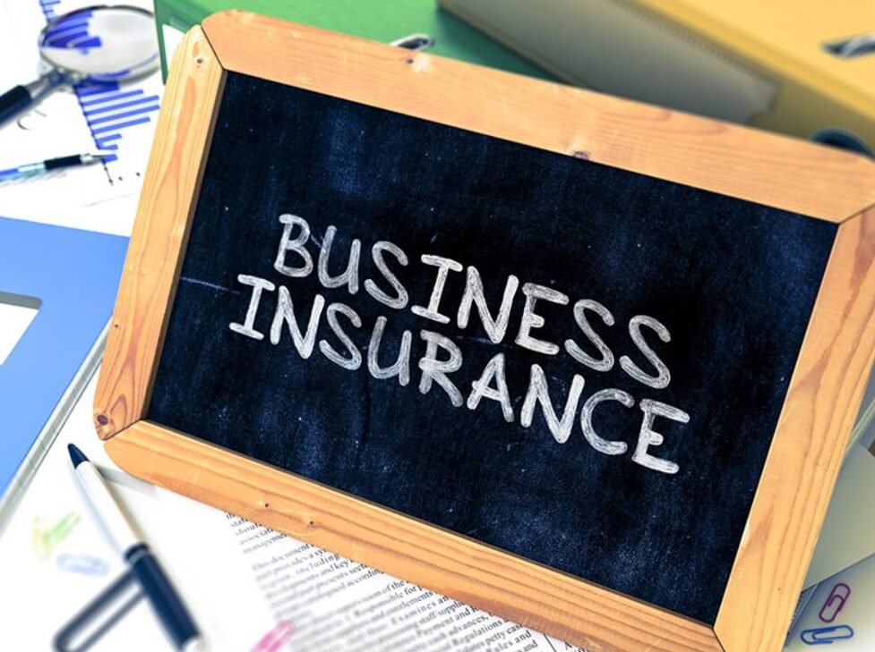 A confident business owner standing outside their storefront in Bexley, Ohio, showcasing the need for comprehensive business insurance to protect their establishment.